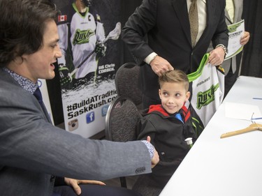 L-R: Saskatchewan Rush captain Chris Corbeil, nine-year-old Cohyn Wells and Rush head coach and general manager Derek Keenan hold a press conference for the signing of a one-day contract of Cohyn to the Saskatchewan Rush, March 26, 2016. Wells is the Saskatchewan representative for the Children's Miracle Network's Champion Program.