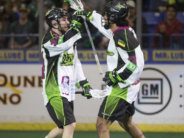 Saskatchewan Rush defence Ryan Dilksin (L) and defence Jeff Cornwall celebrate a goal against the Toronto Rock in NLL action, March 26, 2016.