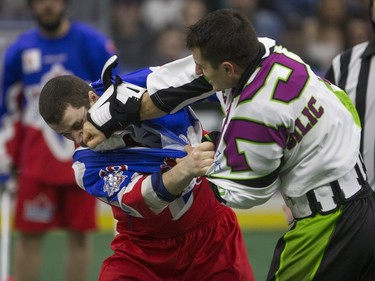 Saskatchewan Rush defense Nik Bilic lands a punch during a fight with Toronto Rock defence Josh Sanderson in NLL action, March 26, 2016.