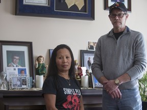 Marilou and Alex Haughey stand with pictures and the ashes of their deceased son J.P. at their home on March 28th, 2016.  J.P died in a violent car crash two years ago. Still, they are struggling to find peace and justice.