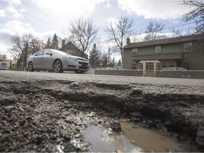 Drivers attempt to avoid potholes near the intersection of Clarence Avenue North and Osler Street on March 31, 2016.