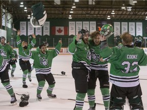 University of Saskatchewan Huskies forward Matthew Spafford, forward John Lawrence, and goalie Jordon Cooke, right, celebrate after defeating the University of Alberta Golden Bears to win the CIS Canada West men's hockey championship on Saturday, March 5th, 2016. (Liam Richards/Saskatoon StarPhoenix)