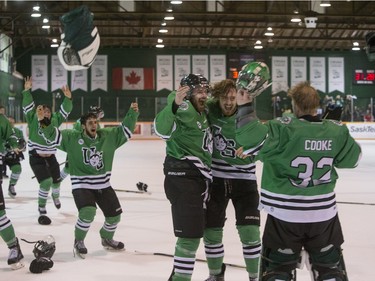 University of Saskatchewan Huskies forward Matthew Spafford and forward John Lawrence, and goalie Jordon Cooke, right, celebrate after defeating the University of Alberta Golden Bears to win the CIS Men's Hockey Canada West championship on Saturday, March 5th, 2016.