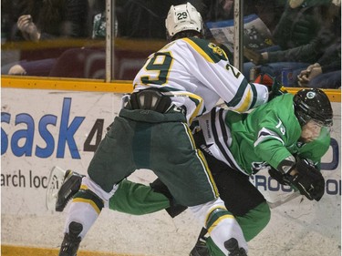 University of Saskatchewan Huskies forward Kohl Bauml is hit from behind by University of Alberta Golden Bears defence Dylan Bredo during 1st period CIS Men's Hockey action on Saturday, March 5th, 2016.