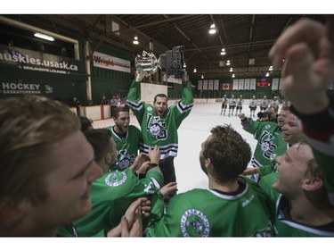 The University of Saskatchewan Huskies celebrate after defeating the University of Alberta Golden Bears to win the CIS Men's Hockey Canada West championship on Saturday, March 5th, 2016.