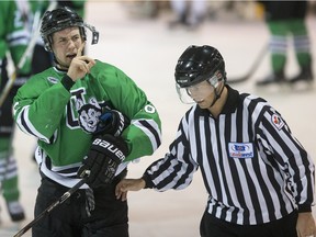 University of Saskatchewan Huskies forward Jesse Ross is confused by his broken visor after an altercation against the University of Alberta Golden Bears in Canada West men's hockey playoff action.