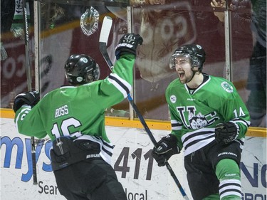 University of Saskatchewan Huskies forward Jesse Ross, left, and froward Logan McVeigh celebrate a goal against the University of Alberta Golden Bears in 3rd period CIS Men's Hockey playoff action on Saturday, March 5th, 2016.