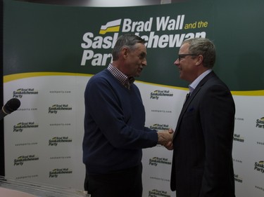 Premier Brad Wall (R) shakes hands with MLA Don Morgan before the revealing of the Saskatchewan Party platform at their Southeast campaign office in Saskatoon, March 19, 2016.