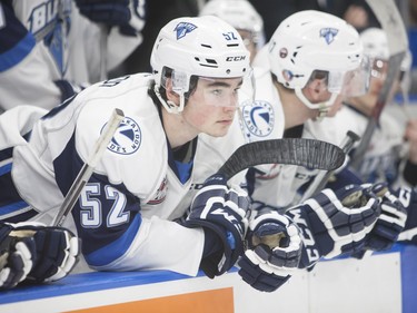 Saskatoon Blades #52 Anthony Bishop waits on the bench during the revealing of the three stars after the win during Saturday night's game at SaskTel Centre in Saskatoon where the Blades took home a 3-2 victory over the Prince Albert Raiders, March 19, 2016.