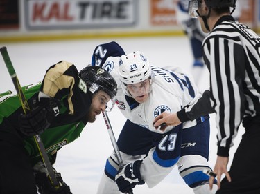 Saskatoon Blades' Braylon Shmyr (R) faces off against Prince Albert Raiders' Kolten Olynek during Saturday night's game at SaskTel Centre in Saskatoon where the Blades took home a 3-2 victory over the Raiders, March 19, 2016.