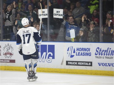 Nick Zajac celebrates with fans after the game at SaskTel Centre where the Saskatoon Blades took home a 3-2 victory over the Prince Albert Raiders in Saskatoon, March 19, 2016.