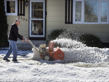 John Smith does a little snow clearing in front of his house on 33rd Street West, March 11, 2016, trying to prevent the melting runoff from making the sidewalks slippery.