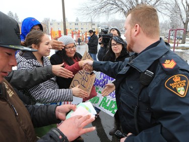 About 60 people gathered in Pleasant Hill Park to rally against the practice of police carding before marching to City Hall, March 15, 2016. Two police service members briefly visited the rally as well.