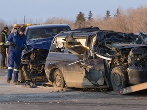 An RCMP collision analyst works at the scene of crash involving a school bus which was struck from behind by a mini-van and truck just south of Dalmeny on Highway 684, Friday, March 18, 2016.