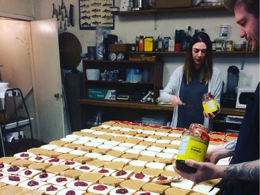 Lindsey Benolken and Kyle Michaels, of The Hollows and Primal restaurants, prepare sandwiches for the Friendship Inn's clients on Monday, March 14, 2016. Instagram Photo courtesy of The Hollows. Saskatoon