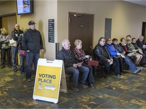 People line up to vote at an advance poll in the Circle Drive Alliance Church, Wednesday, March 30, 2016.