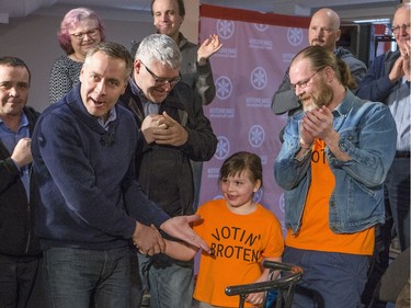 NDP leader Cam Broten points out the shirt of a young supporter as he hosts a town-hall style event at Federation Des Francophones Saskatoon, March 31, 2016.