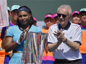Serena Williams stands with tournament director Raymond Moore after Victoria Azarenka, defeated Williams in a final at the BNP Paribas Open tennis tournament, Sunday, March 20, 2016, in Indian Wells, Calif. Azarenka won 6-4, 6-4.