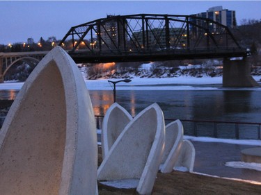 Signs of spring are starting to emerge, as night is coming later and later in the City of Saskatoon. The remaining span of the Traffic Bridge can be seen in the fading evening light in this photo taken near the Launch Time sculptures by Prairie Design Group located at River Landing on March 8, 2016.