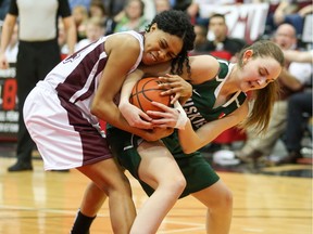 U of S Huskies' player Megan Ahlstrom tussles for the ball during the national women's basketball semifinal. The Huskies beat the Saint Mary's Huskies 65-58 to advance to the championship game.