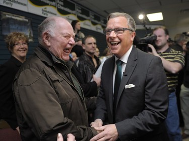 Brad Wall (R) shares a laugh with supporter Ross Huckle (L) during the Saskatchewan Party's election campaign kick-off in Saskatoon, March 8, 2016.
