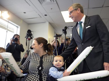 Brad Wall (R) greets supporter Danielle Tochor (L) and her son James during the Saskatchewan Party's election campaign kick-off in Saskatoon, March 8, 2016.