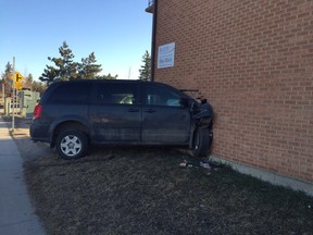 A 20-year-old man was arrested after a van crashed into a building at the intersection of Acadia Drive and 14th Street East on Friday, April 8, 2016.