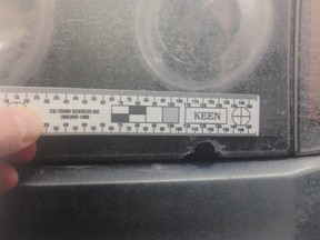 A court exhibit photo shows what appears to be a bullet hole in the driver's side headlight of Nathan Huzan-Aalen's car. Abdirahman Mohamed Islow and Omar Abidiaziz Issak are on trial for discharging a firearm with reckless intent following an incident in a parking lot on Eighth Street East in Saskatoon on March 28, 2015. Charges were stayed against a third accused.