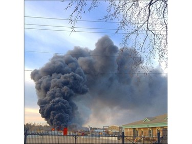 Saskatoon firefighters battle a blaze at an auto salvage yard at Avenue P and 14th Street West in Saskatoon on April 19, 2016.