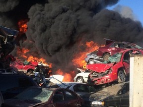 Saskatoon firefighters battle a blaze at an auto salvage yard at Avenue P and 14th Street West in Saskatoon on April 19, 2016.