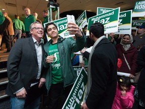 Ayaz Fiaz snaps a selfie with Saskatchewan Party leader Brad Wall, left, during a Saskatchewan Party rally in Regina on Friday April 1, 2016. The Saskatchewan provincial election takes place Monday, April 4.