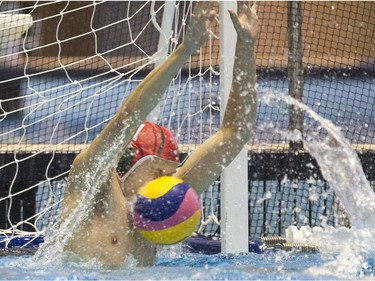 Saskatchewan goalie Brody McKnight makes a save with his face against Team Saanich during the 16U National League Men's and Women's Western Conference water polo championships at Shaw Centre on April 10, 2016.