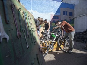 Stan Yu helps with some repairs at the Bridge City Bike Coop on Saturday, April 16th, 2016. The BCBC has been flooded with Syrian families looking for bikes.