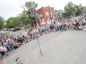 Jamey Mossengren performs during the 2015 Fringe festival last August at the intersection of Broadway Avenue and 10th Street. Pipe replacement work at this intersection is slated to be completed by mid-June, but road resurfacing may still be taking place when this year's Fringe is staged starting July 28.