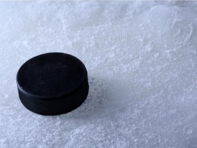 Black hockey puck on ice rink background Source: Fotolia