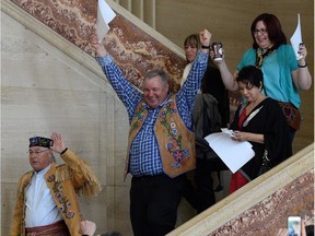 Metis National Council President Clement Chartier, left, and David Chartrand, president of the Manitoba Metis Federation, middle, celebrate following a decision at the Supreme Court of Canada in Ottawa on April 14, 2016.