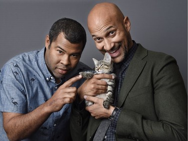 Jordan Peele (L) and Keegan-Michael Key hold a ten-week-old tabby as they pose for a portrait to promote "Keanu," at The Beverly Hilton Hotel in Beverly Hills, California, April 23, 2016.
