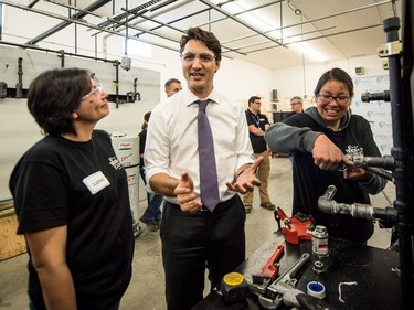 Prime Minister Justin Trudeau gets a demonstration from Luthell Sutherland and Rebecca Rabbitskin at the YWCA Trade Journey Program at Saskatchewan Polytechnic in Saskatoon, April 27, 2016.