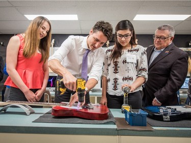 Prime Minister Justin Trudeau helps build a guitar with students at Oskayak High School in Saskatoon, April 27, 2016.