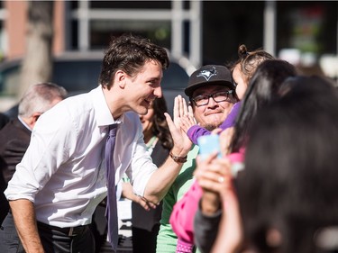 Prime Minister Justin Trudeau greets people on his way to Oskayak High School in Saskatoon, April 27, 2016.