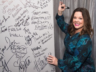 Melissa McCarthy signs the wall at AOL Studios after participating in AOL's BUILD Speaker Series to discuss her new film "The Boss" on April 6, 2016 in New York.