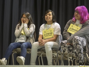 Makayla Cannepotato (L) reacts after winning the Junior competition in the first ever First Nations Provincial Spelling Bee, as second place finisher Brittney Bugler (C) and third place Cheyenne Gunn (R) look on at the Don Ross Centre in North Battleford, April 8, 2016.