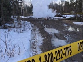 Police tape marks off a smouldering house on the Pikangikum First Nation in Ontario.