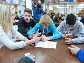 Grade nine Campbell Collegiate students Abby Saunderson, Tariq Al-Katib, Nolan Schauerte, Ahmed Maftah and Joseph Young use their mobiles to participate at a Student First Anti-Bullying Forum at Campbell Collegiate n Regina, SK on November 17, 2015. The province says they have received 61 reports of bullying through its online reporting tool, and while some say numbers are low, the ministry has heard the new tool is helping battle bullying.