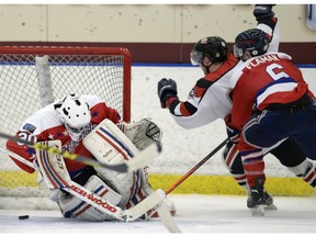 REGINA,Sk: APRIL 14, 2016 - Saskatoon's Chris Thorimbert 21 celebrates a goal on Regina's Carson Bodgan 30 during the first game of the Keystone cup Between the Regina Extreme Hockey Capitals and the Saskatoon Quakers in Regina Thursday morning. BRYAN SCHLOSSER