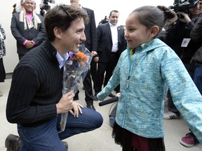 Prime Minister Justin Trudeau meets 7 year old Keslee Bear from Muskowpeetin first nation as he arrives at the Treaty Four Governance Centre in Fort Qu'Appelle Saskatchewan Tuesday April 26, 2016 before meeting with the leaders of the File Hills Tribal Council.