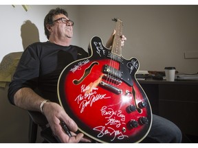 Local businessman and guitar collector Lou Paquette is donating his Eagles-autographed guitar to Egadz.