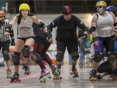 Team White takes on Team Black in a Invitational Scrimmage at the home opener for the Saskatoon Roller Derby League at Archibald Arena, April 2, 2016.