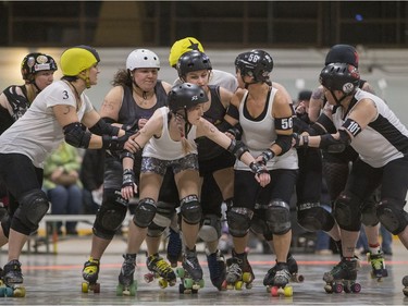 Team White takes on Team Black in a Invitational Scrimmage at the home opener for the Saskatoon Roller Derby League at Archibald Arena, April 2, 2016.