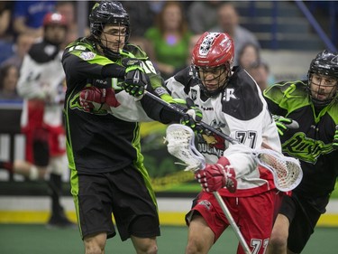 Saskatchewan Rush defence Chris Corbeil. left and defence Kyle Rubisch put pressure on Calgary Roughnecks forward Jeff Shattler in NLL action on Saturday, April 2nd, 2016.